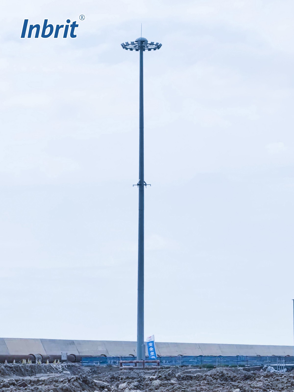 Full-height view of the Inbrit 35m high mast light pole at an open project site Full-height view of the Inbrit 35m high mast light pole at an open project site